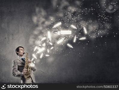 Handsome saxophonist. Young man playing saxophone and lightbulbs coming out
