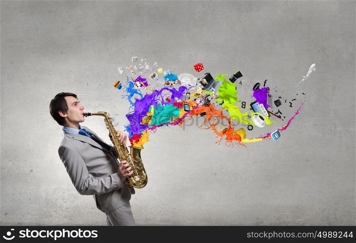 Handsome saxophonist. Young man playing saxophone and paint splashes coming out