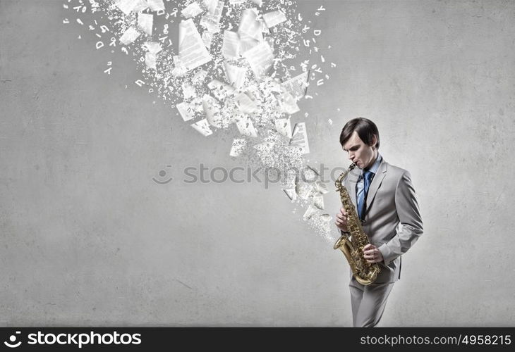 Handsome saxophonist. Young man playing saxophone and papers coming out