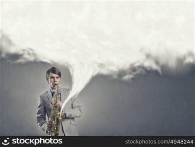 Handsome saxophonist. Young man playing saxophone and white cloud coming out