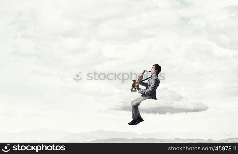 Handsome saxophonist. Young man sitting on cloud playing saxophone