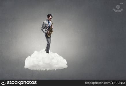Handsome saxophonist. Young man standing on cloud playing saxophone