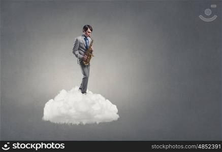 Handsome saxophonist. Young man standing on cloud playing saxophone