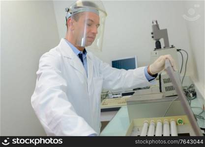 handsome scientist doing reserches with state of the art machines