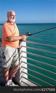 Handsome senior man enjoys spending his retirement fishing.