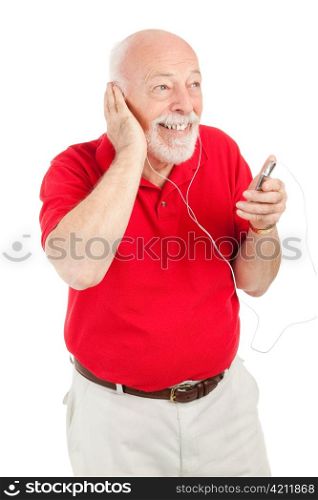 Handsome senior man having fun listening to music on a portable mp3 player. Isolated on white.