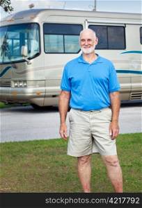 Handsome senior man posing in front of his luxury RV.