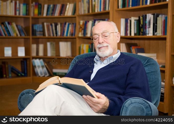 Handsome senior man relaxing with a good book. Plenty of room for text.