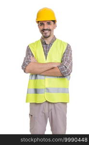 Handsome smiling male builder in hardhat and vest standing with crossed arms on white background and looking at camera. Cheerful male constructor standing with crossed arms