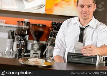 Handsome smiling male waiter giving receipt czech crowns in pub