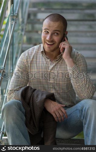 Handsome stylish businessman speaking on the phone in office