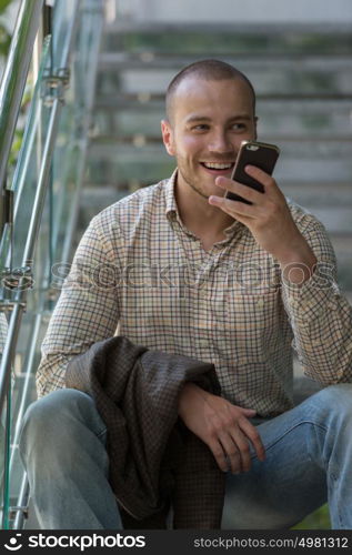 Handsome stylish businessman speaking on the phone in office