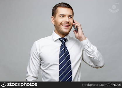 Handsome stylish caucasian businessman on grey background with copy space. Handsome stylish businessman on grey background