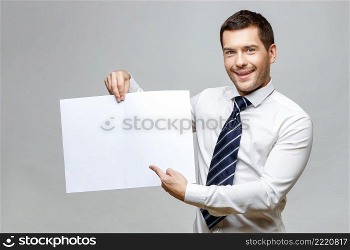 Handsome stylish caucasian businessman on grey background with copy space. Handsome stylish businessman on grey background