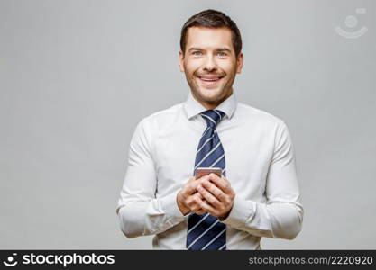 Handsome stylish caucasian businessman on grey background with copy space. Handsome stylish businessman on grey background