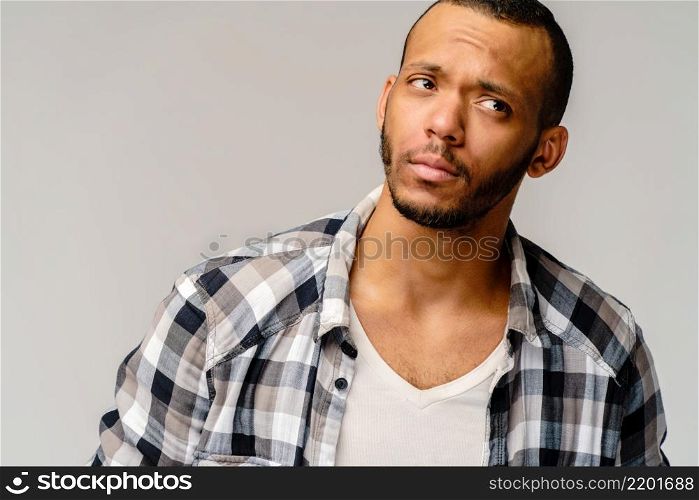 Handsome stylish young african american man wearing shirt - looking disturbed or confused.. Handsome stylish young african american man wearing shirt - looking disturbed or confused