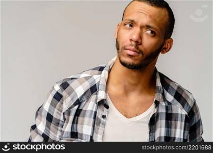Handsome stylish young african american man wearing shirt - looking disturbed or confused.. Handsome stylish young african american man wearing shirt - looking disturbed or confused
