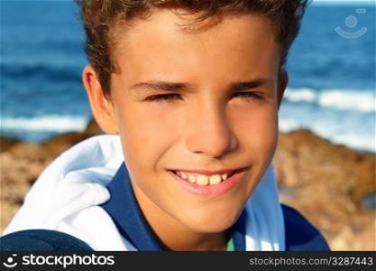 handsome teenager boy closeup portrait smiling outdoor beach