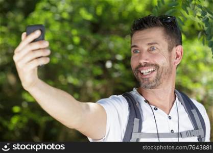 handsome traveller man taking a selfie on his excursion
