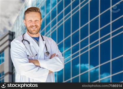 Handsome Young Adult Male Doctor With Beard In Front of Hospital Building.