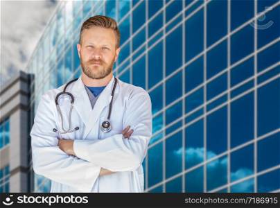 Handsome Young Adult Male Doctor With Beard In Front of Hospital Building.