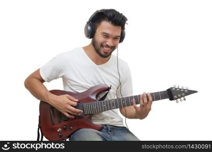 Handsome young asian men playing guitar and listen music with headphones,Blurry and soft focus
