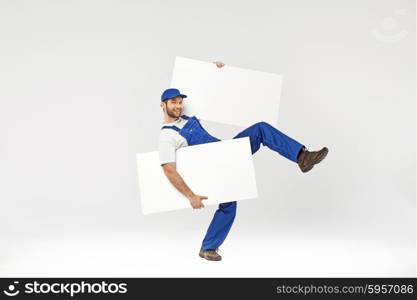 Handsome young builder holding white boards