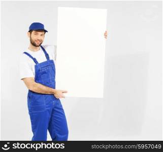 Handsome young builder with white board
