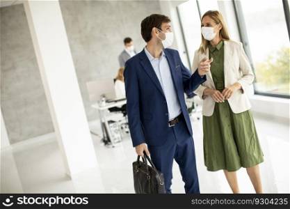 Handsome young business couple walking together while wear protective masks to prevent   corona viruus at office space