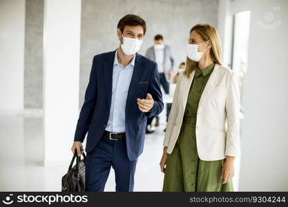 Handsome young business couple walking together while wear protective masks to prevent   corona viruus at office space