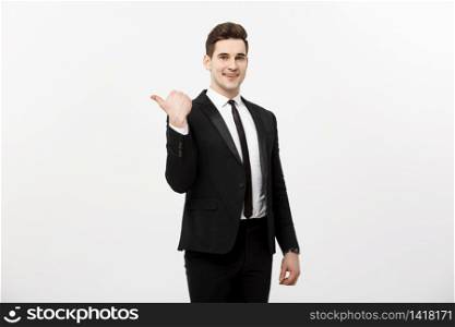 Handsome young business man happy smile point finger to empty copy space, businessman showing pointing side, concept of advertisement product, isolated over white background. Handsome young business man happy smile point finger to empty copy space, businessman showing pointing side, concept of advertisement product, isolated over white background.