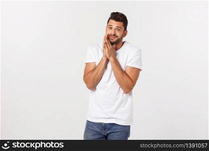 Handsome young business man standing praying, isolated over white background. Concept of idea, ask question, think up, choose, decide. Handsome young business man standing praying, isolated over white background. Concept of idea, ask question, think up, choose, decide.
