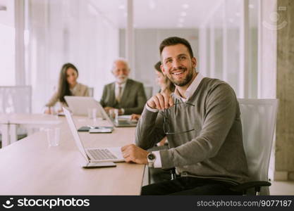 Handsome young business man working on laptop in the office