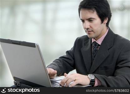 Handsome young business man working with laptop