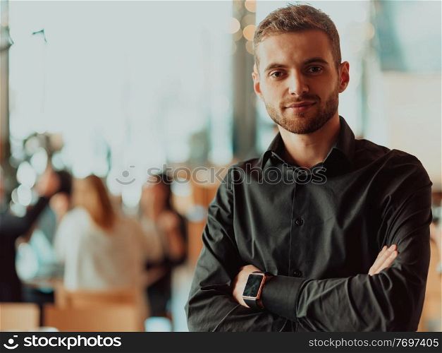 Handsome young businessman in the office. Cheerful self-confident professional man with crossed hands portrait. Business success concept. Cheerful self confident professional businessman with crossed hands portrait.