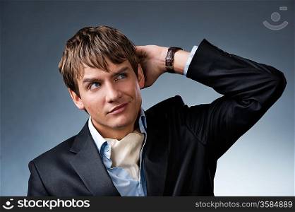 Handsome young businessman isolated on grey background