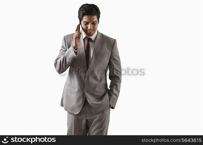 Handsome young businessman on call over white background