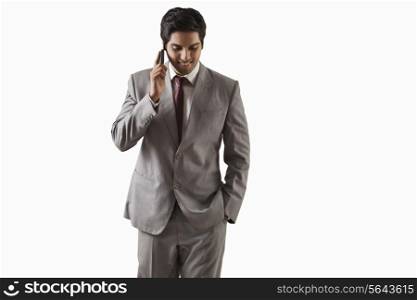 Handsome young businessman on call over white background