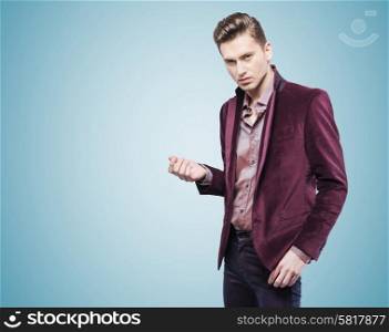 Handsome young businessman over the blue background