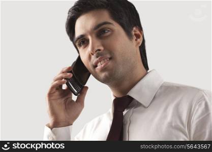 Handsome young businessman speaking on cell phone