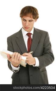 Handsome young businessman taking notes. Isolated on white.