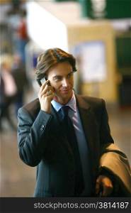 Handsome young businessman talking on mobile phone
