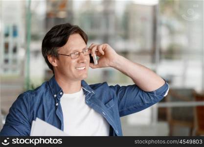 Handsome young businessman talking over phone