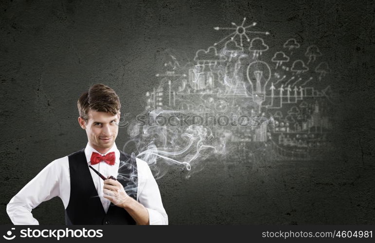 Handsome young businessman thinking over ideas and smoking pipe. Businessman and pipe smoke