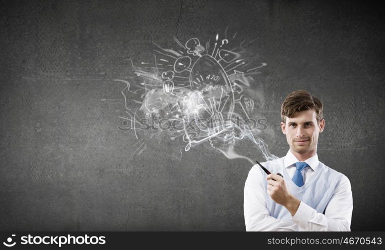 Handsome young businessman thinking over ideas and smoking pipe. Businessman and pipe smoke