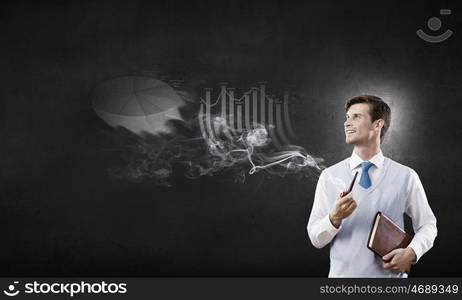 Handsome young businessman thinking over ideas and smoking pipe. Businessman and pipe smoke