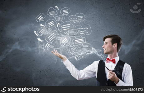 Handsome young businessman thinking over ideas and smoking pipe. Businessman and pipe smoke