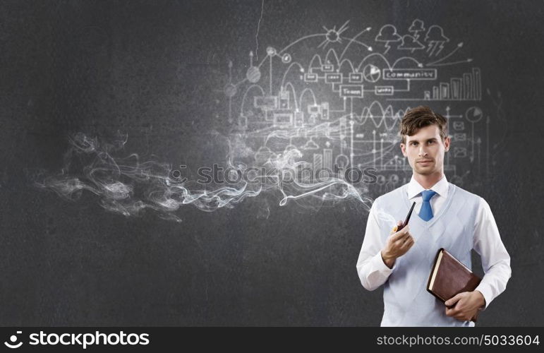 Handsome young businessman thinking over ideas and smoking pipe. Businessman and pipe smoke