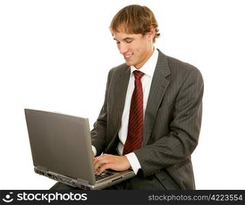 Handsome young businessman typing on his laptop. Isolated on white.