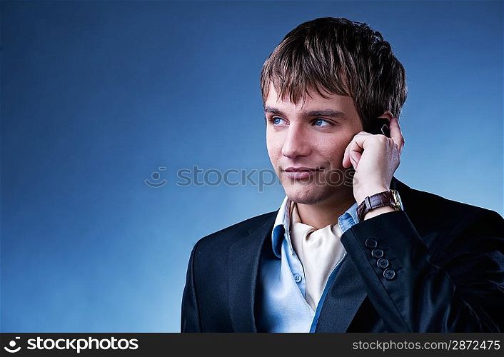 Handsome young businessman with a mobile phone